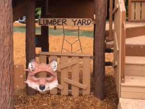 Market sign with counter under a TreeLine structure where kids can "play store"